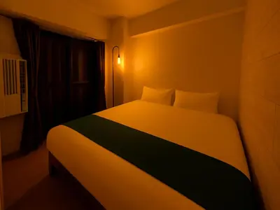 a bedroom with a bed with a light on it at Shinjuku,5min Walk to Higashi-Shinjuku sta & Shinjuku Sta,King Bed,ree Wi-Fi in Tokyo