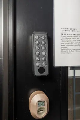 a remote control on a door with a sign at Koiwa Station Entire Villa Two Generation House with 1BR Cozy Apartment and 4BR Spacious Home Easy JR Access to Asakusa Skytree Shinjuku Shibuya Ueno and Narita Haneda Airport in Tokyo