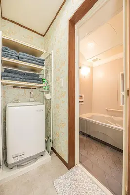 a bathroom with a walk in shower and a tub at Koiwa Station Entire Villa Two Generation House with 1BR Cozy Apartment and 4BR Spacious Home Easy JR Access to Asakusa Skytree Shinjuku Shibuya Ueno and Narita Haneda Airport in Tokyo