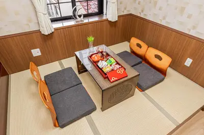 an overhead view of a table and chairs in a room at Koiwa Station Entire Villa Two Generation House with 1BR Cozy Apartment and 4BR Spacious Home Easy JR Access to Asakusa Skytree Shinjuku Shibuya Ueno and Narita Haneda Airport in Tokyo