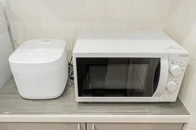 a microwave and a toaster oven sitting on a shelf at Koiwa Station Entire Villa Two Generation House with 1BR Cozy Apartment and 4BR Spacious Home Easy JR Access to Asakusa Skytree Shinjuku Shibuya Ueno and Narita Haneda Airport in Tokyo