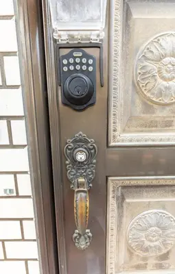 a bronze door with a lock on it at Minimalism HOTEL Asakusa in Tokyo