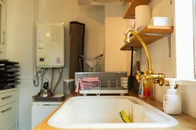a kitchen counter with a sink and a sink at Minimalism HOTEL Asakusa in Tokyo