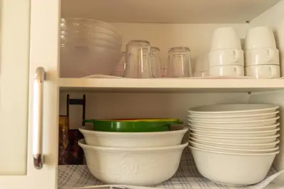 a cupboard filled with plates and bowls and dishes at Minimalism HOTEL Asakusa in Tokyo