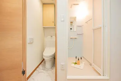 a small bathroom with a toilet and a mirror at \u685c\u306e\u5ddd70-44 \u6c60\u888b\u99c5 7\u5206 2-4\u4eba\u4e28Ikebukuro 7 minutes 2-4 people in Tokyo