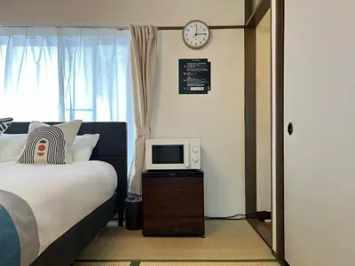 a bedroom with a bed and a tv on a table at nestay suite tokyo Takadanobaba in Tokyo