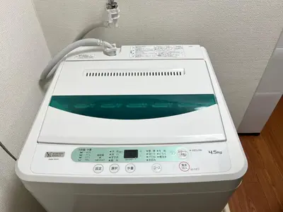 a close up of a washing machine in a room at nestay suite tokyo Takadanobaba in Tokyo