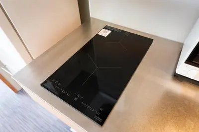 a microwave sitting on top of a counter at NEIJU Apartment Hotel - Live Like a Local in Nakano - Direct Shinjuku Access in Tokyo