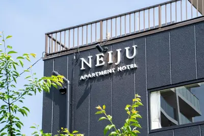 a sign on the side of a building at NEIJU Apartment Hotel - Live Like a Local in Nakano - Direct Shinjuku Access in Tokyo