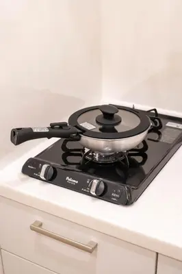 a pot on top of a stove on a counter at \u5c0f\u718a\u306e\u5bb6 129Ta in Tokyo