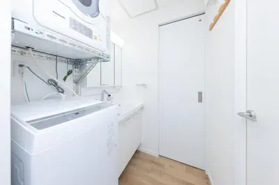 a white kitchen with white cabinets and a sink at \u5c0f\u718aAnnex 129Tb in Tokyo
