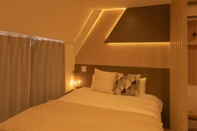 a bedroom with a bed with a light above it at \u5c0f\u718aAnnex 129Tb in Tokyo