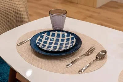 a table with a plate and a glass and utensils at \u5c0f\u718aAnnex 129Tb in Tokyo
