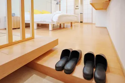 a row of black shoes on the floor in a bedroom at YYT New listing, 30 seconds walk from the subway, high-speed Wi-Fi, complete facilities, convenient surroundings, high cost performance in Tokyo