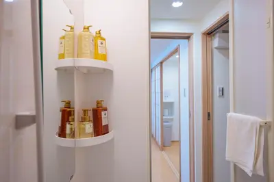 a bathroom with bottles of oils on a wall at YYT New listing, 30 seconds walk from the subway, high-speed Wi-Fi, complete facilities, convenient surroundings, high cost performance in Tokyo
