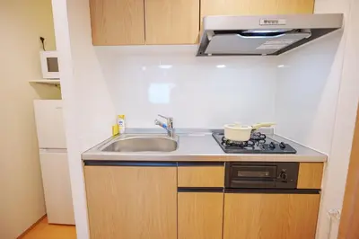 a small kitchen with a sink and a stove at YYT New listing, 30 seconds walk from the subway, high-speed Wi-Fi, complete facilities, convenient surroundings, high cost performance in Tokyo