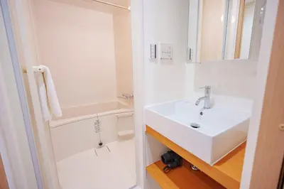 a white bathroom with a sink and a shower at YYT New listing, 30 seconds walk from the subway, high-speed Wi-Fi, complete facilities, convenient surroundings, high cost performance in Tokyo