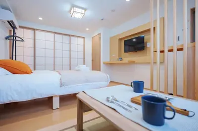 a room with two beds and a table with a table sidx sidx sidx at YYT New listing, 30 seconds walk from the subway, high-speed Wi-Fi, complete facilities, convenient surroundings, high cost performance in Tokyo