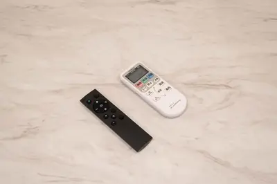a remote control sitting on a counter next to a remote controller at \u5922\u306e\u5bbf \u6b05 138t in Tokyo
