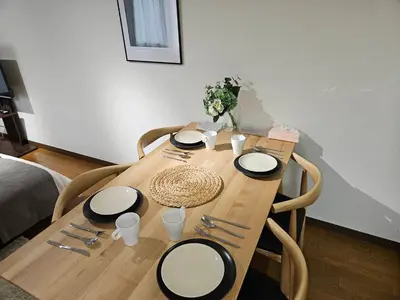a wooden table with plates and utensils on it at \u30db\u30c6\u30eb\u30ec\u30b9\u30dd\u30ef\u30fc\u30eb303 in Tokyo