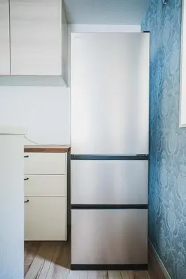 a refrigerator in a kitchen with white cabinets at 18min to Disney by Taxi Luxury Mattress 3BR 74 square meter in Tokyo