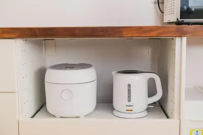 two appliances are sitting on a shelf at 18min to Disney by Taxi Luxury Mattress 3BR 74 square meter in Tokyo