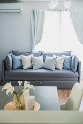 a living room with a blue couch and a table at 18min to Disney by Taxi Luxury Mattress 3BR 74 square meter in Tokyo