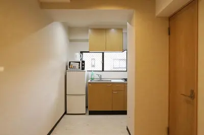 a kitchen with a white refrigerator and a sink at Maple Ginkgo Views Autumn Stay Up To 8 in Tokyo