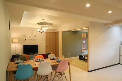 a dining room with a table and some chairs at Maple Ginkgo Views Autumn Stay Up To 8 in Tokyo