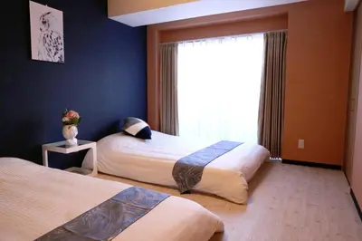 a hotel room with two beds and a window at Maple Ginkgo Views Autumn Stay Up To 8 in Tokyo