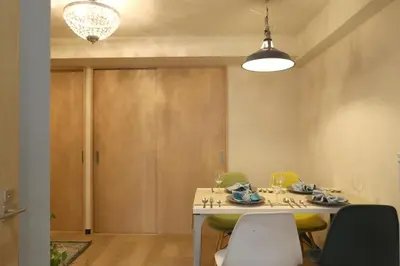 a dining room with a table and green chairs at N202 Ikebukuro Shinjuku Up to 6 guests in Tokyo