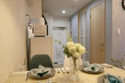 a dining room table with a vase of flowers on it at N202 Ikebukuro Shinjuku Up to 6 guests in Tokyo