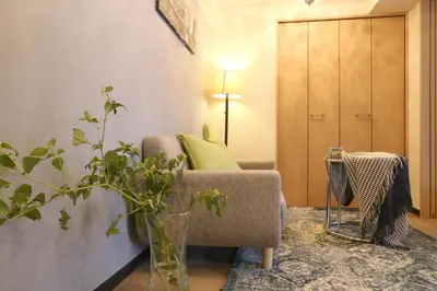a living room with a couch and a vase with a plant at N202 Ikebukuro Shinjuku Up to 6 guests in Tokyo