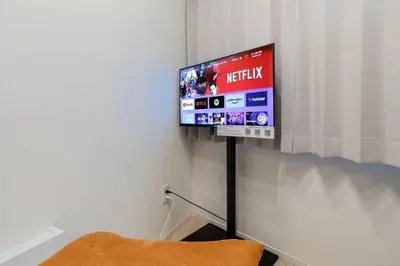 a television on a wall in a room at \u30d1\u30fc\u30af\u30b7\u30fc\u30c9\u65b9\u5357\u753a in Tokyo