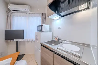 a small kitchen with a sink and a microwave at \u30d1\u30fc\u30af\u30b7\u30fc\u30c9\u65b9\u5357\u753a in Tokyo