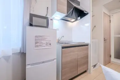 a small kitchen with a sink and a microwave at \u30d1\u30fc\u30af\u30b7\u30fc\u30c9\u65b9\u5357\u753a in Tokyo