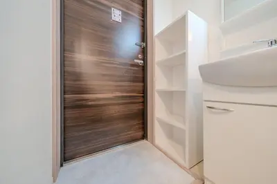a wooden door in a bathroom next to a sink at \u30d1\u30fc\u30af\u30b7\u30fc\u30c9\u65b9\u5357\u753a in Tokyo