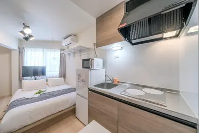 a small kitchen with a sink and a microwave at \u30d1\u30fc\u30af\u30b7\u30fc\u30c9\u65b9\u5357\u753a in Tokyo