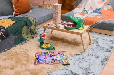 a living room with a couch and a table with toys at 4K Cinema Duplex, 8 Guests, 4 min in Tokyo
