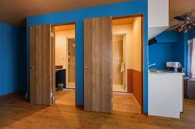 a kitchen with three open doors in a room at 4K Cinema Duplex, 8 Guests, 4 min in Tokyo