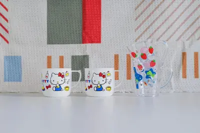 three coffee cups with hello kitty on them on a shelf at Pop playful accommodation for family, 4 people, 4 min in Tokyo