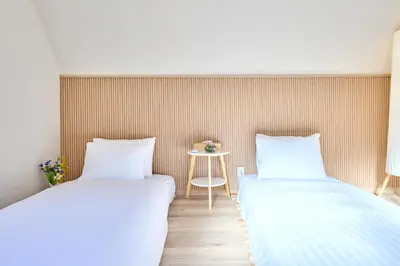 two beds sitting next to each other in a room at STAY ARI Higashishinjuku in Tokyo