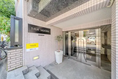 a store front with a sign that reads that sexism at T-Flat SASAZUKA in Tokyo