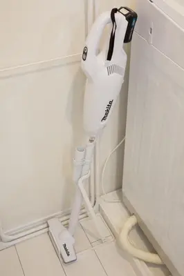 a hairdryer on a stand next to a wall at Kokoon Hotel Ebisu in Tokyo