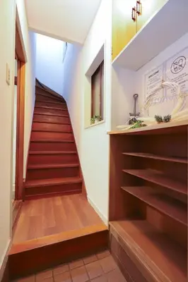 a staircase in a house with wooden floors and a stair case at \u5800\u52074\u4e01\u76ee\u6238\u5efa in Tokyo