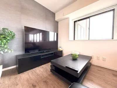 a living room with a large flat screen tv at 東京最上階の豪邸ステイ 最上階270度ビュー&スカイツリーを望む 最大8名貸切 上野浅草秋葉原近く 無料WiFi アルカディア北千住 in Tokyo