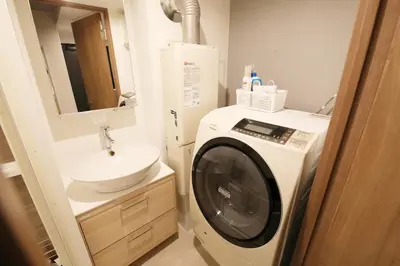 a bathroom with a washing machine and a sink at Heureux\u690e\u540d\u753a202 in Tokyo