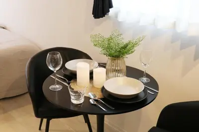 a black table with plates and wine glasses on it at Heureux\u690e\u540d\u753a202 in Tokyo