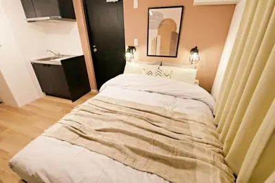 a bedroom with a large bed in a room at Relax Family Inn IKEBUKURO in Tokyo