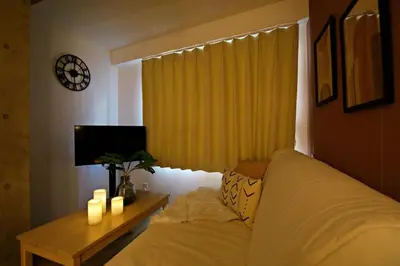 a bedroom with a bed and a table with candles at Relax Family Inn IKEBUKURO in Tokyo
